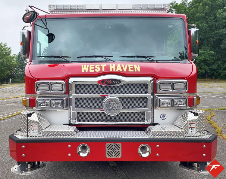 Head-on front view showing grille, bumper, and warning lights