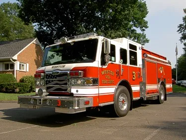 Pumper front-left exterior view showing enclosed cab and side compartments