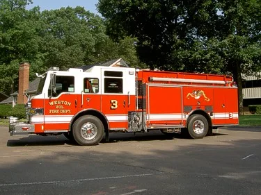 Driver-side profile view showing pump panel area and side body compartments