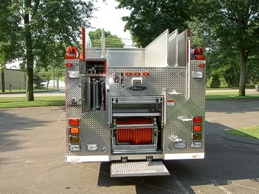 Rear view with lower compartment open showing hose storage and rear lighting