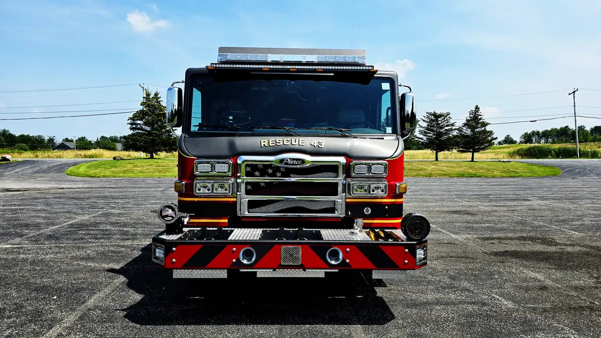 Head-on front view showing grille, bumper intakes, and warning lights