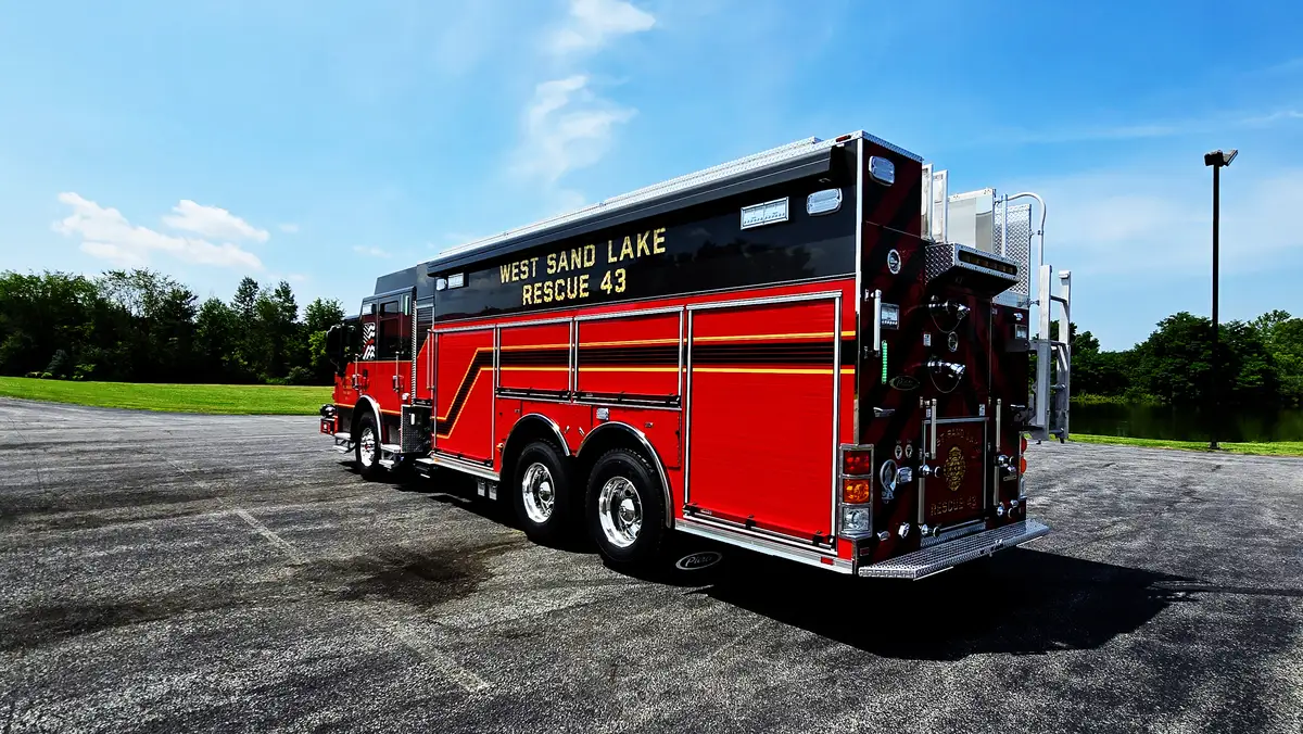 Driver-side profile view showing long rescue body and side compartments