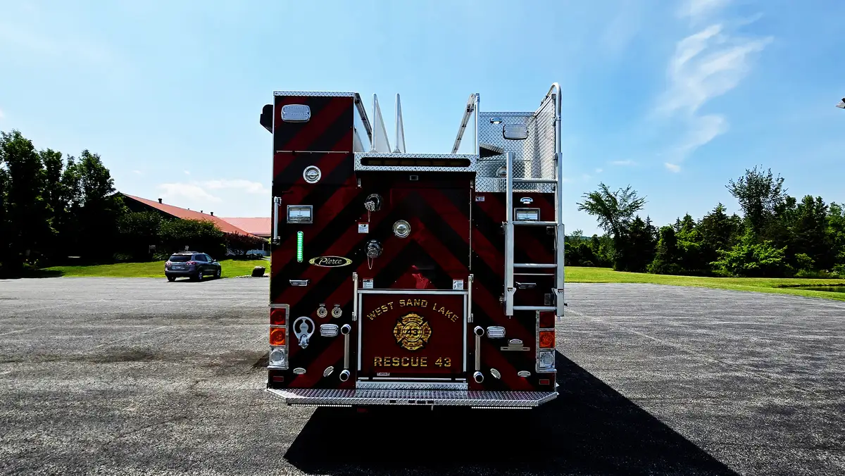 Rear view showing red-and-yellow chevrons and rear compartment doors