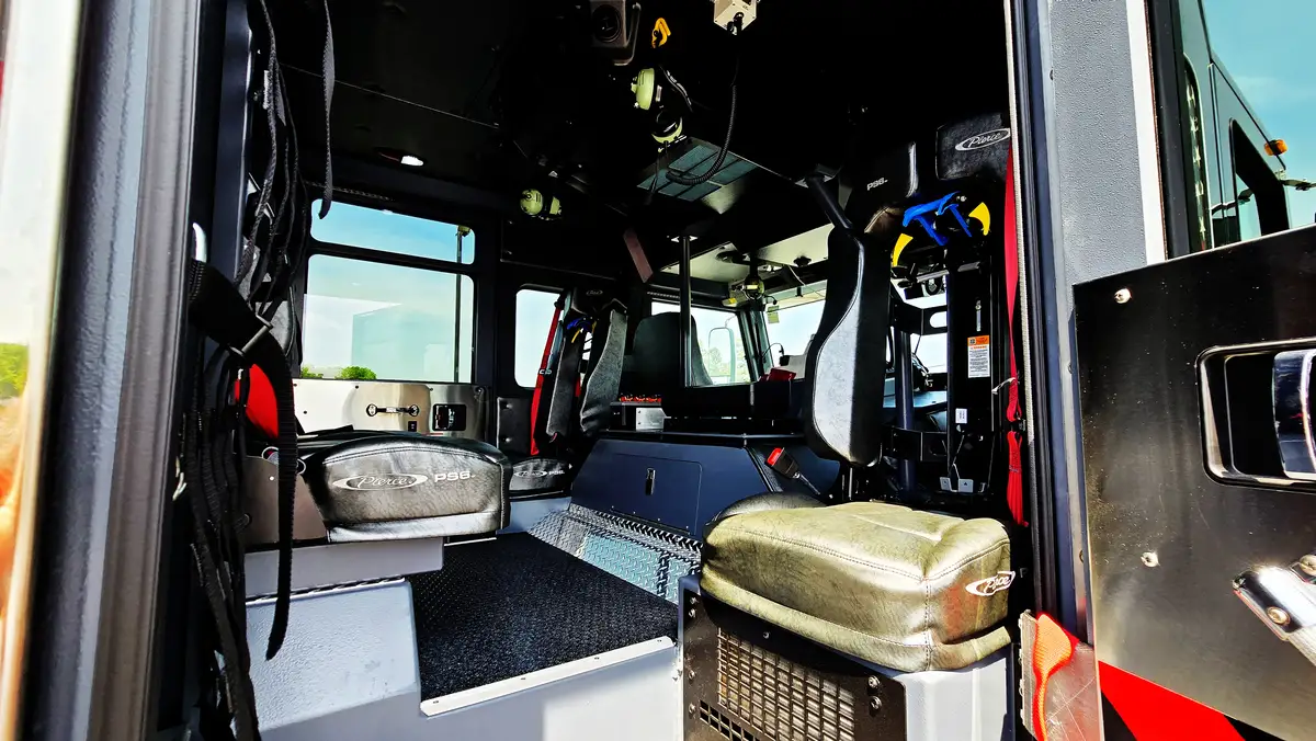 Crew cab interior view showing rear seats and side equipment rack