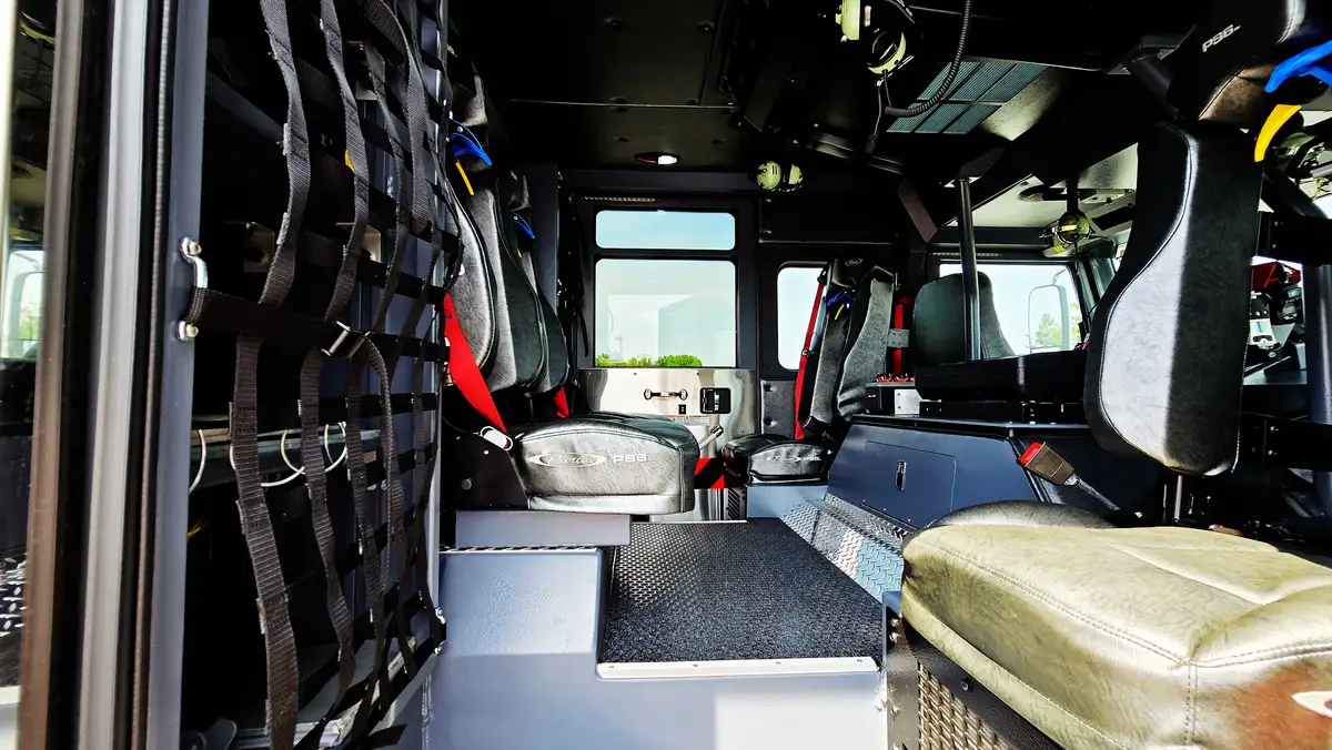 Rear crew interior view showing seat row and gear rack