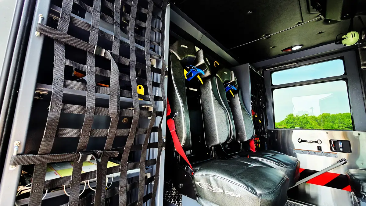 Crew seating area view showing SCBA seats and cargo net storage