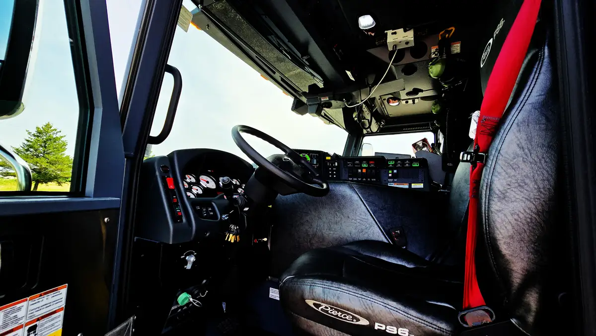 Driver cockpit view showing steering wheel, dashboard, and center controls