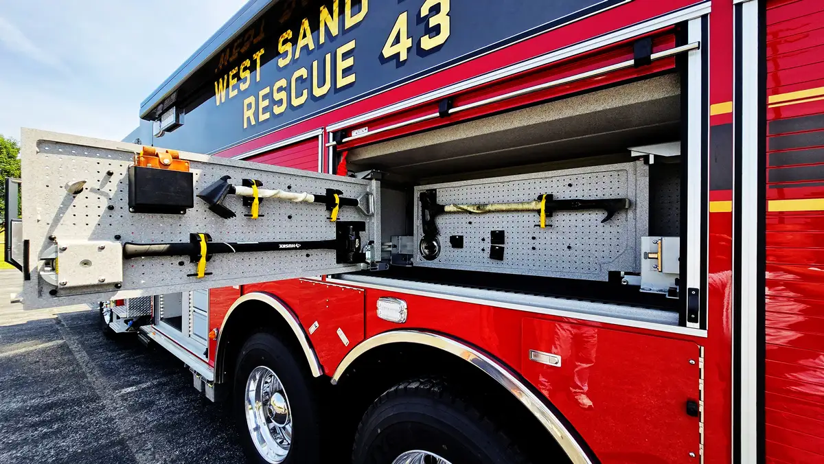 Open side compartment with pull-out tray showing tool bins and equipment