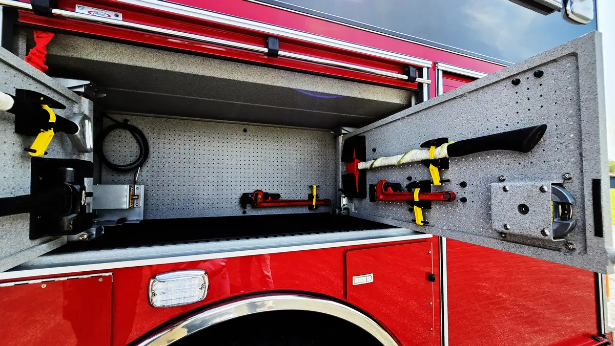 Open side compartment showing shelving and mounted gear space