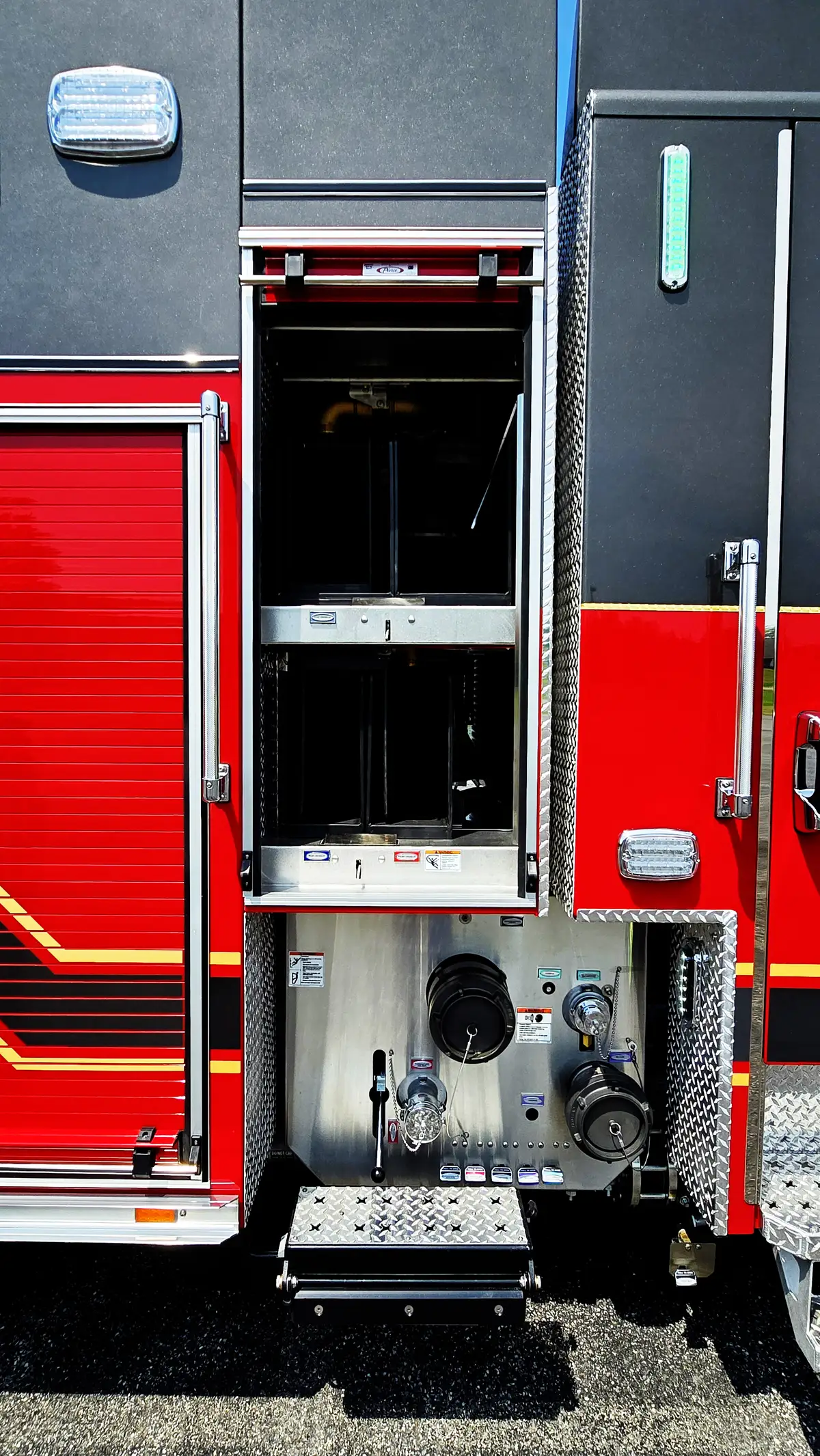 Open rear-side compartment showing stacked equipment bins