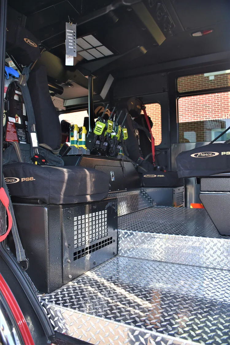Cab interior side view showing rear seat and center aisle area