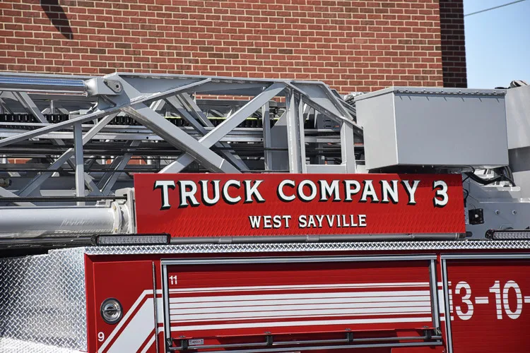 Ladder beam close-up showing truck company lettering on red panel