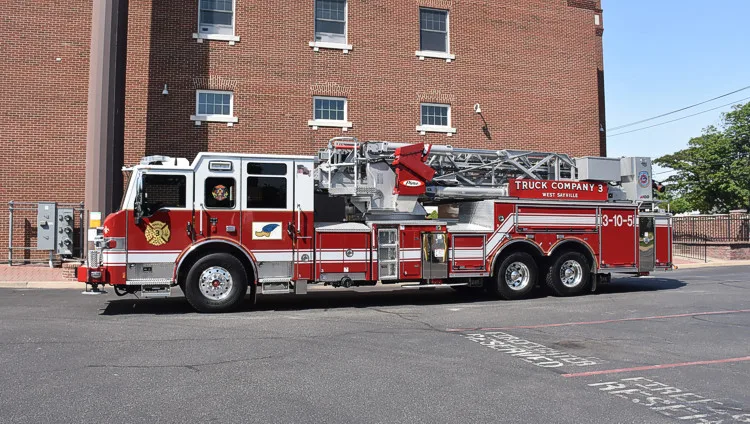 Tower ladder truck side profile showing full body and ladder sections