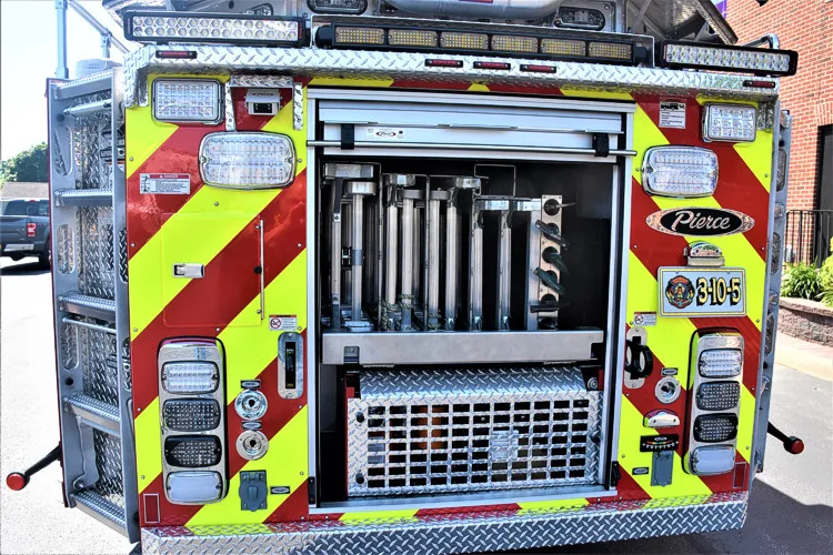 Rear view showing red-and-yellow chevrons and open rear center compartment