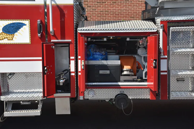 Open side compartment showing shelf storage and lower tray near rear wheel
