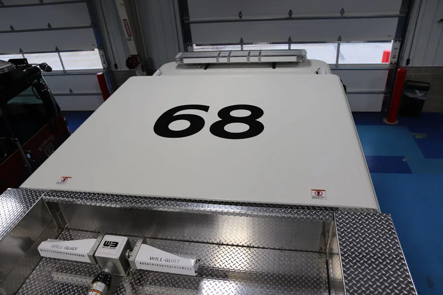 Top deck close-up showing white panel surface and large black unit number