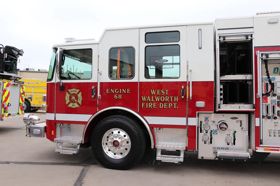 Driver-side profile view showing pump panel and open side compartment