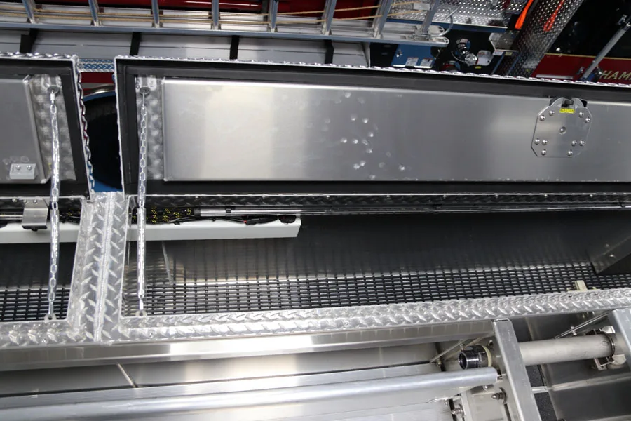 Open side compartment close-up showing shelf surfaces and diamond-plate trim