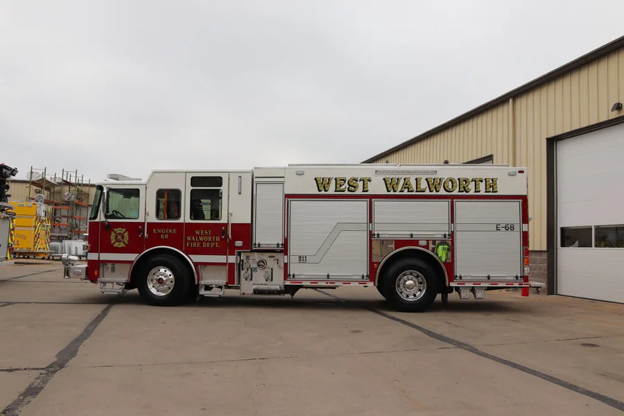 Driver-side full profile view showing long side body and compartment layout