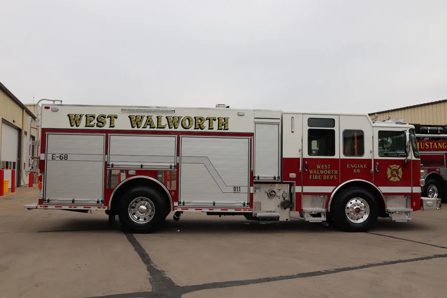 Officer-side full profile view showing pumper body and rear chevrons