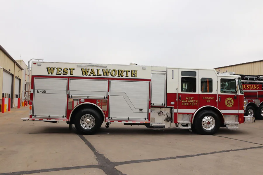 Driver-side full profile view with closed roll-up doors and side body