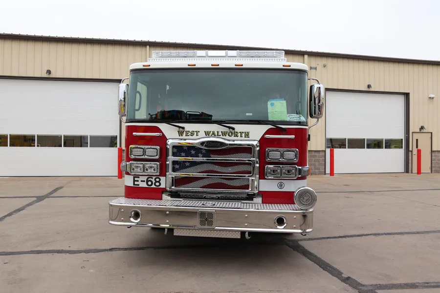 Head-on front view showing grille, bumper intake, and warning lights