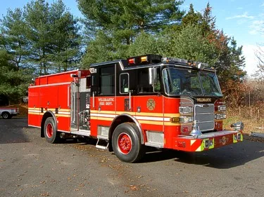 Front right side view showing full apparatus length, side compartments, and wheel/tire layout.