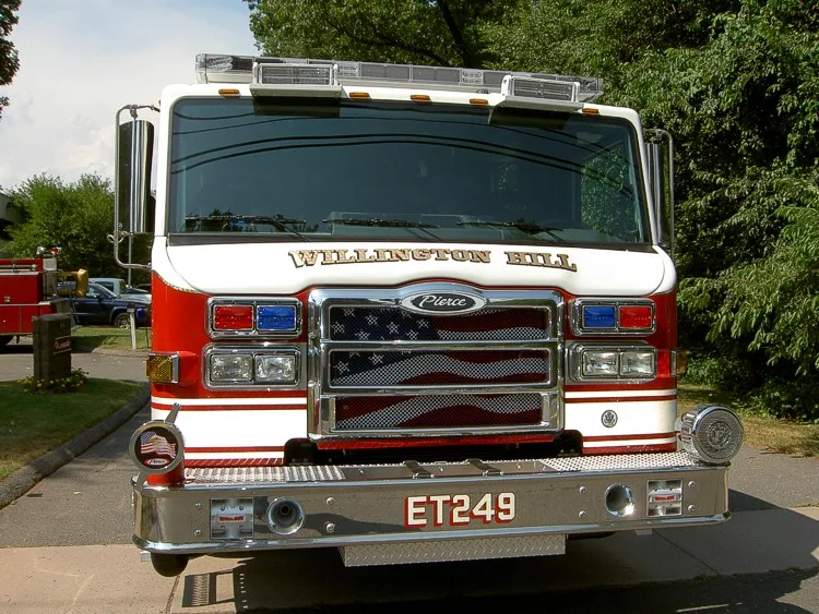 Front exterior view showing grille, bumper, and warning lights