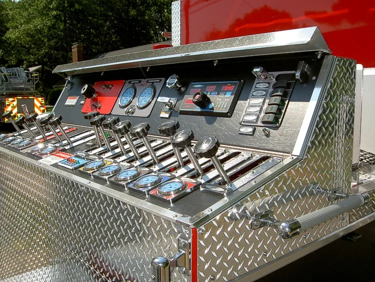 Top-mounted pump panel close-up showing gauges, levers, and controls