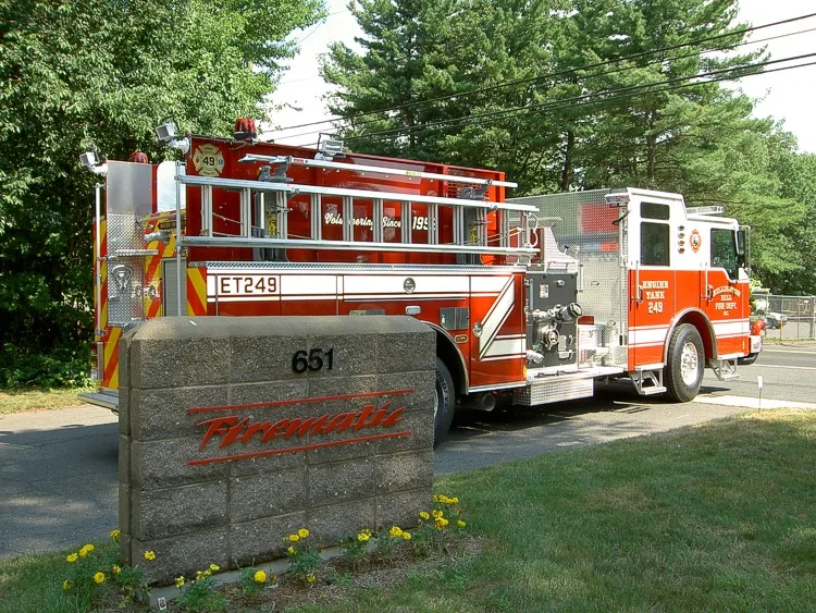 Rear-left exterior view showing side hosebed rails and rear body