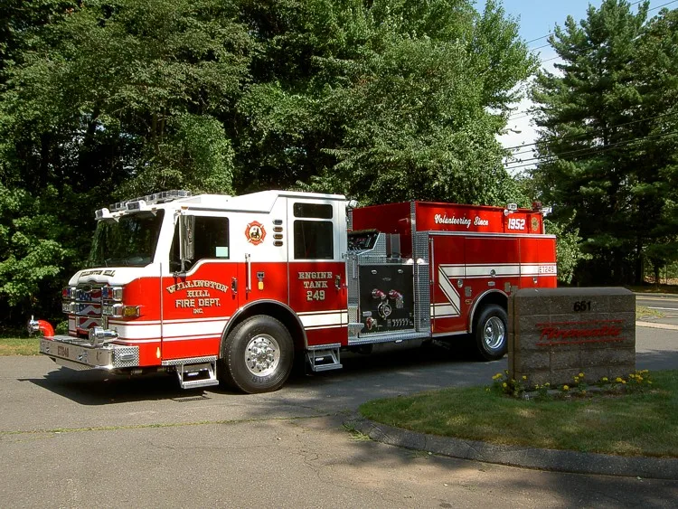 Driver-side profile view showing side compartments and pump panel