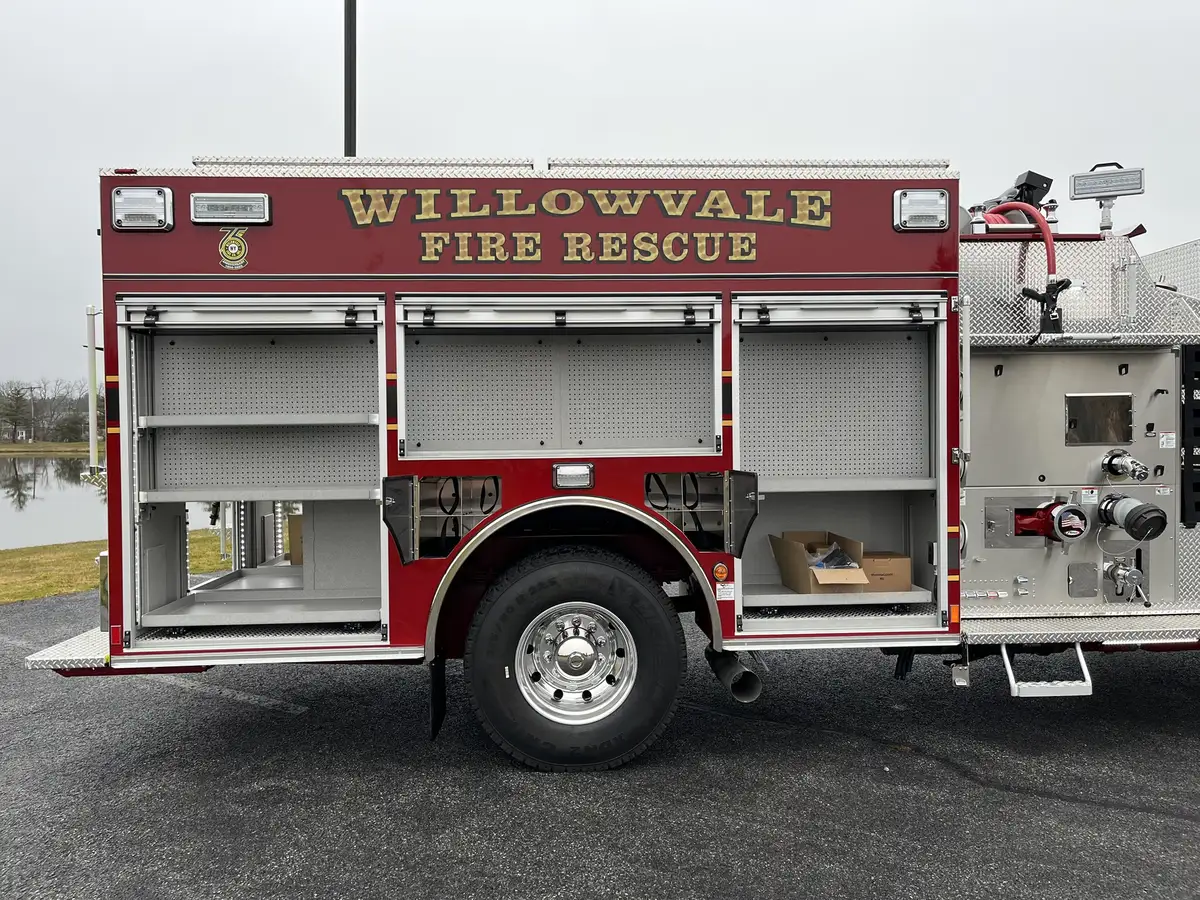 Driver-side compartment view with roll-up doors open and rear wheel
