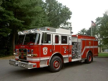 Front-left exterior view with open compartment and visible pump panel area