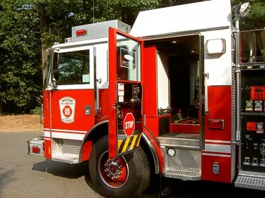 Rear crew door open view showing cab step, interior entry, and rear wheel area