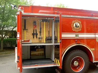 Open side compartment view showing long-handled tools and storage shelf