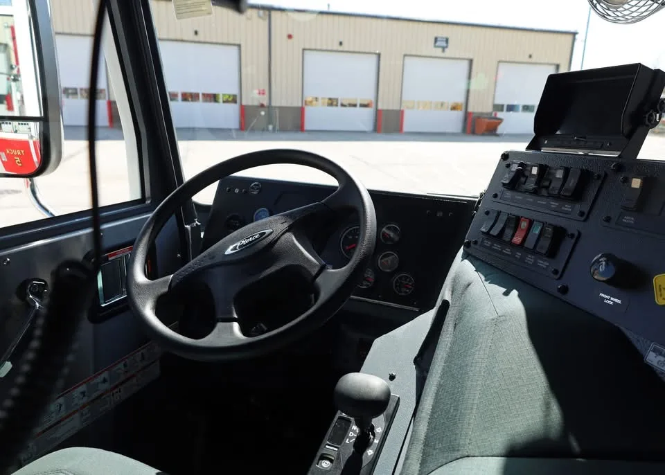 Driver cockpit view showing steering wheel, dashboard, and center console
