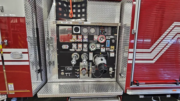 Pump panel close-up showing gauge cluster, valves, and control levers