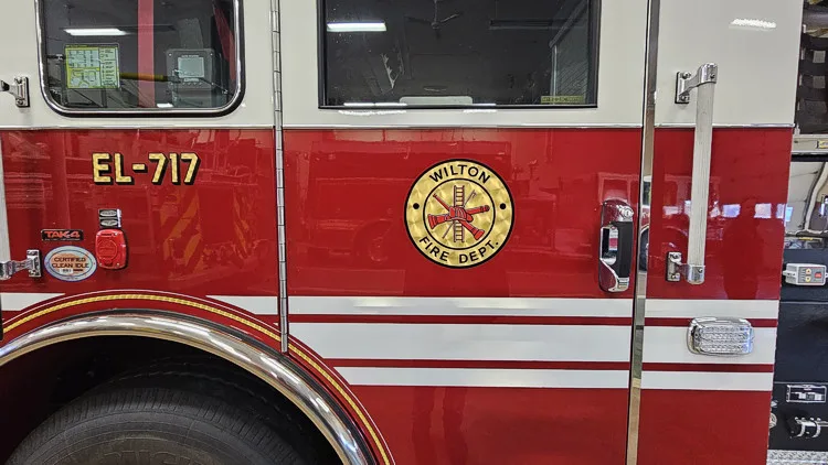 Cab-side close-up showing city crest and unit number on red panel