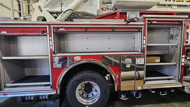 Open side compartment showing shelf storage and wheel area