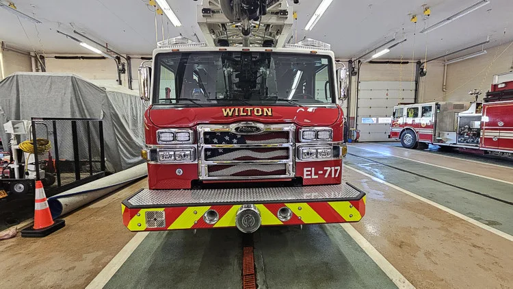Rear view showing red-and-yellow chevrons and head-on cab in bay