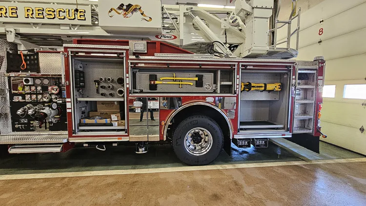 Driver-side profile with open compartment showing pump controls and panel area