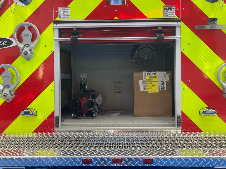 Rear chevron close-up with open center compartment and lower storage bay