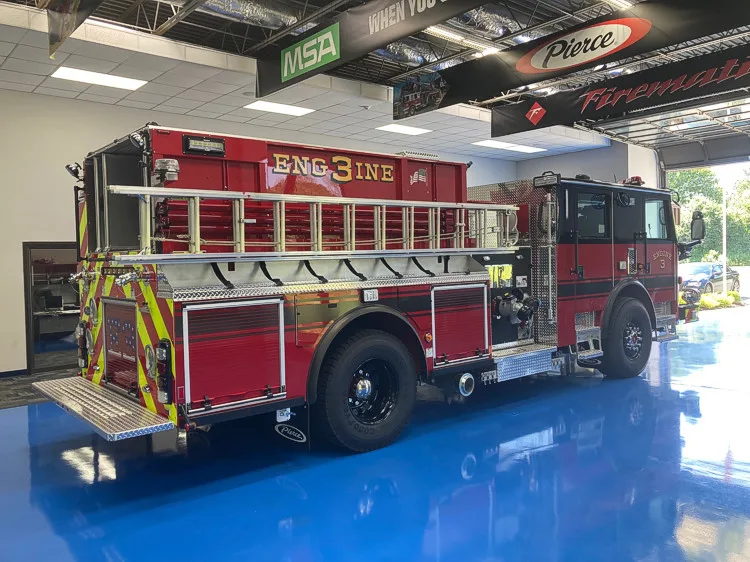 Driver-side profile showing pumper body and rear wheel area