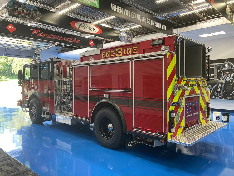 Driver-side profile view showing side compartments and rear chevrons