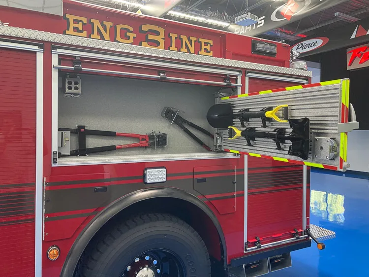 Open side compartment showing mounted long tools and hand tools