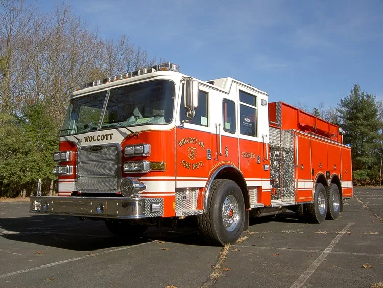 Front-left exterior view showing the grille, bumper, cab, and tanker body compartments.