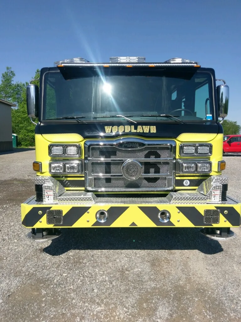 Front exterior view showing grille, bumper, and warning lights