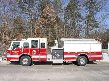 Full right-side profile showing cab, pump panel controls, compartment doors, and wheel/tire layout.