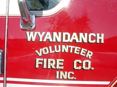 Close-up of side door lettering on the cab panel above the white stripe.