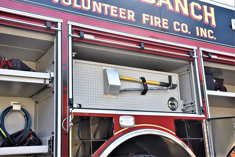 Open side compartment showing mounted hand tools and long-tool rack
